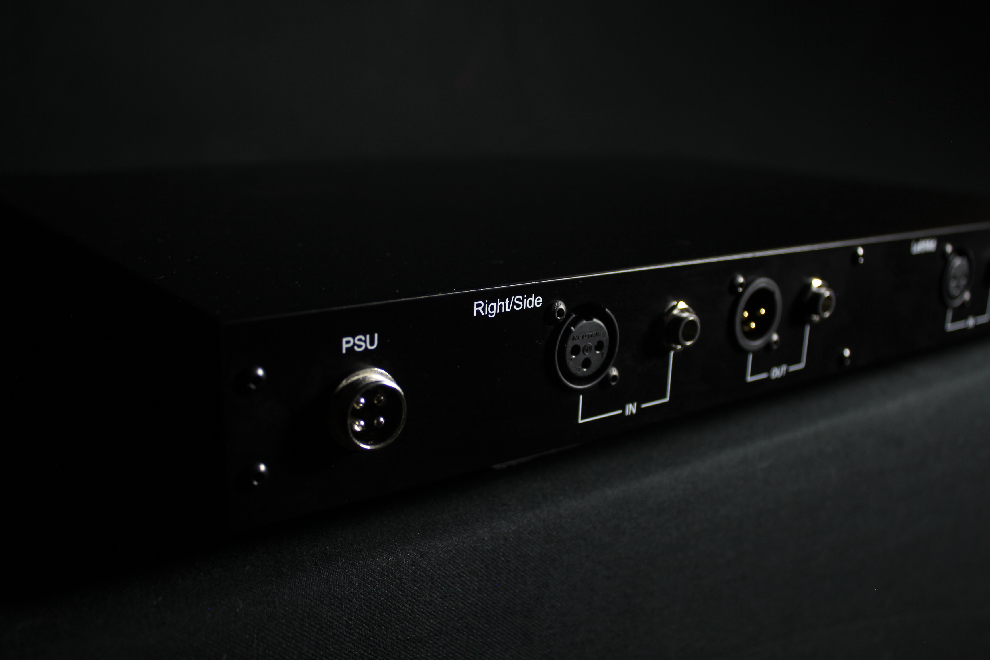 Rear panel at an angle: external power supply connector and the Right/Side XLR and jack input and output